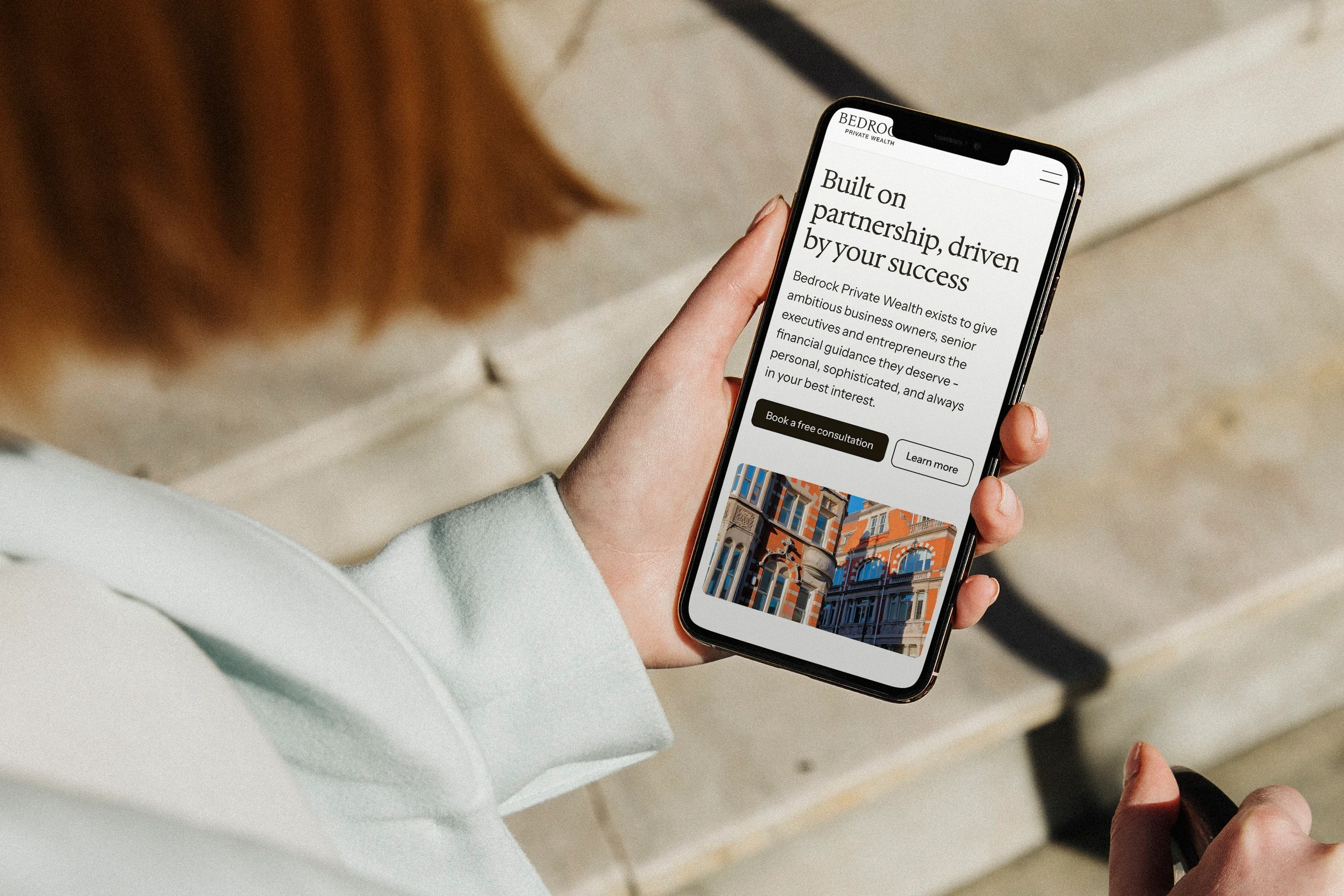 The About page on a phone, held outdoors